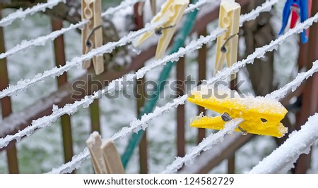 clothes peg under ice and snow