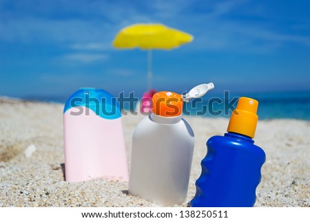 suntan lotion bottles in the sand