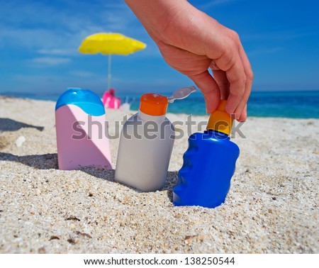 girl holding a suntan lotion bottle