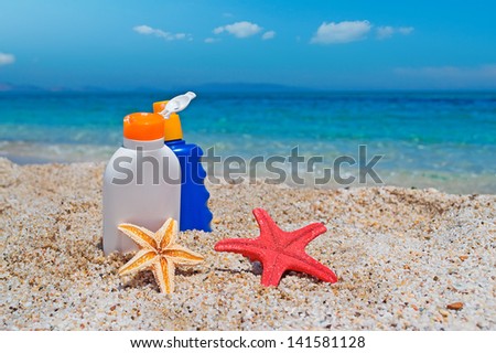 suntan lotion bottles and starfish at the beach