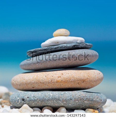 stone pile on white pebbles by the shore