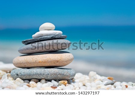 stone pile on white pebbles by the shore