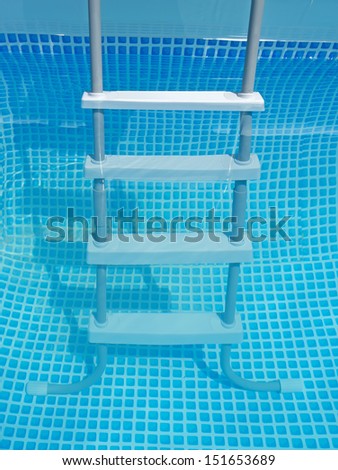 close up of a pool ladder in the water