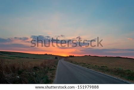 country road under a scenic sunset