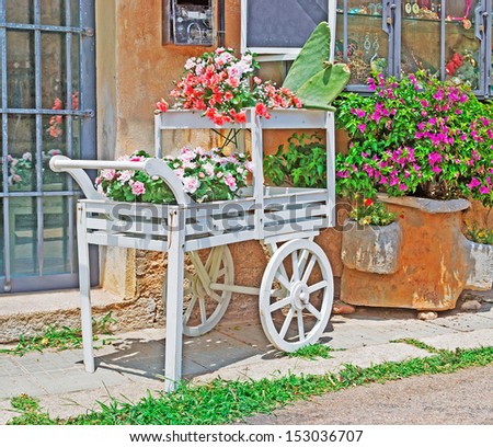 white cart with flowers by the street