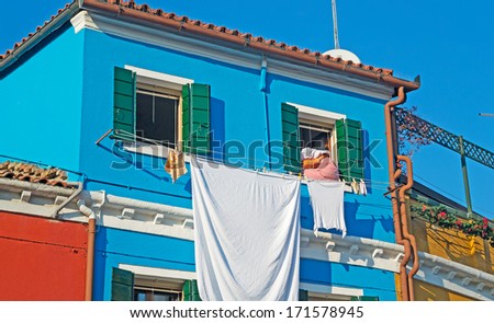 laundry line with clothes in a Burano facade