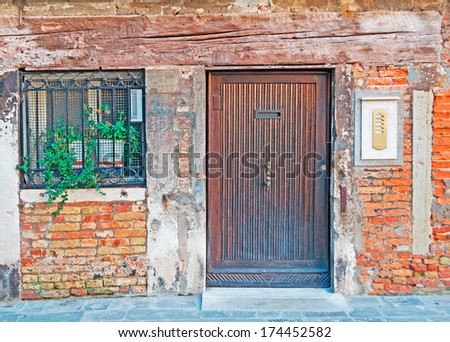 grungy door and window in an old wall in Venice, Italy