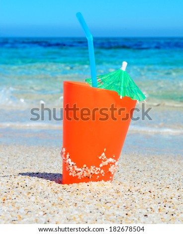 orange drink by the shore