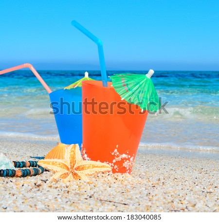 blue and orange drinks by the sea