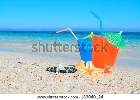 blue and orange drinks by the sea