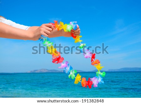 girl holding a hawaiian necklace
