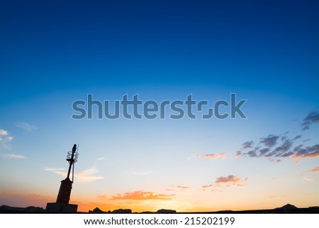 lighthouse silhouette at sunset in Alghero harbor