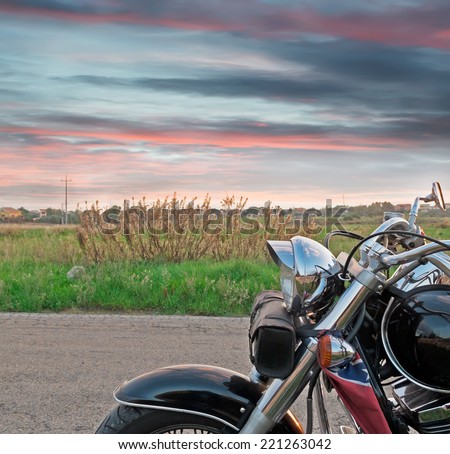 SASSARI, ITALY-NOVEMBER 16, 2012: chromed motorcycle on the edge of the road at sunset