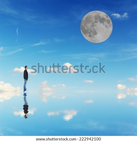 man looking at the moon in a blue background