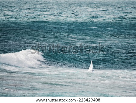 white boat sailing in the storm