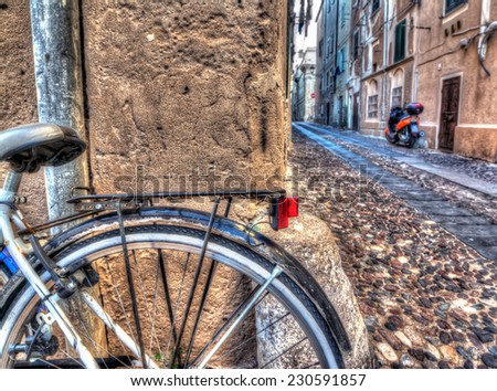 Close up of a bike wheel in Alghero old town. Heavy processed for hdr tone mapping effect.