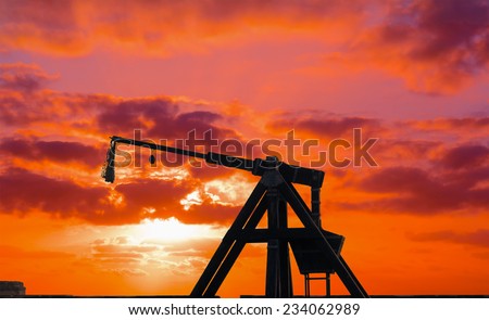 catapult silhouette under a red sunset. Shot in Alghero, Italy.