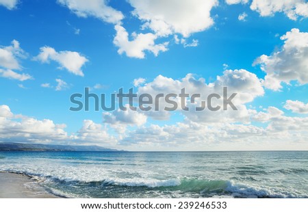 waves in Le Bombarde beach under clouds. Shot in Alghero, Italy.