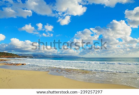 waves in Le Bombarde beach under clouds. Shot in Alghero, Italy.