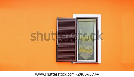 brown shutters in an orange wall