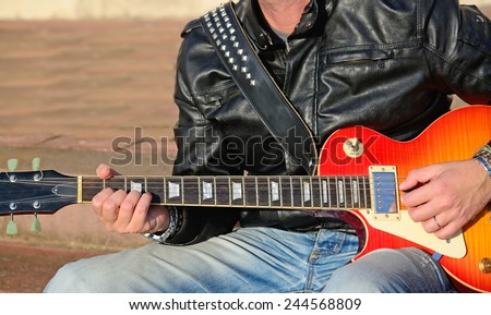 closeup of a guitar player with electric guitar
