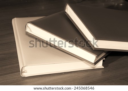 books on a wooden desk in vintage tone