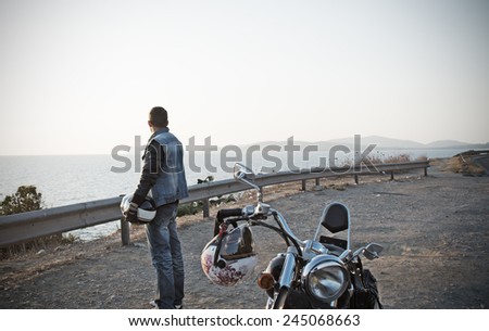 biker and motorcycle by the sea in vintage tone effect