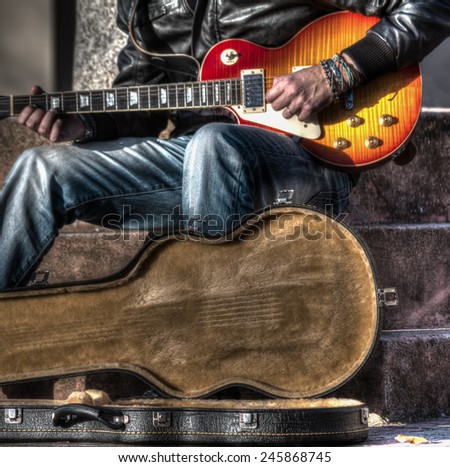 guitar player with an open guitar case in hdr