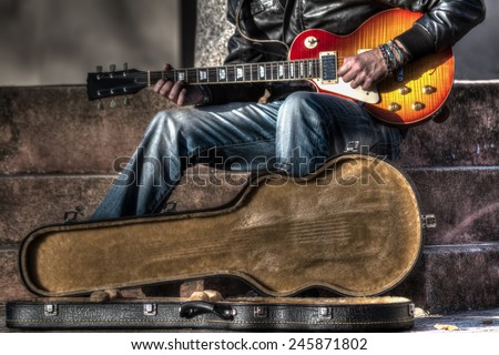 guitar player with an open guitar case in hdr