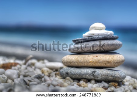 stones pile on white pebbles by the shore. Processed for hdr tone mapping effect