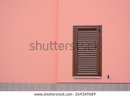 brown shutter in a pink wall with copy space