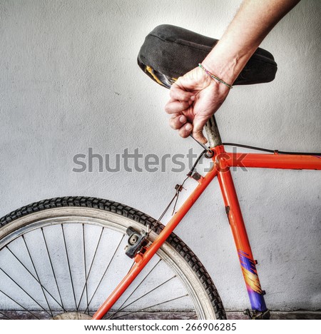 man repairing a mountain bike in a workshop. Processed for hdr tone mapping effect