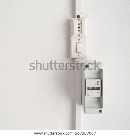 electricity meter in a white wall with copy space