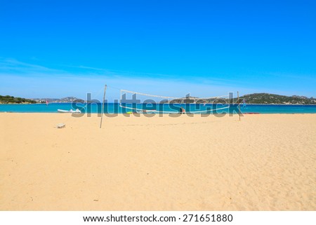 beach volley net and surfers in Porto Pollo beach, Sardinia
