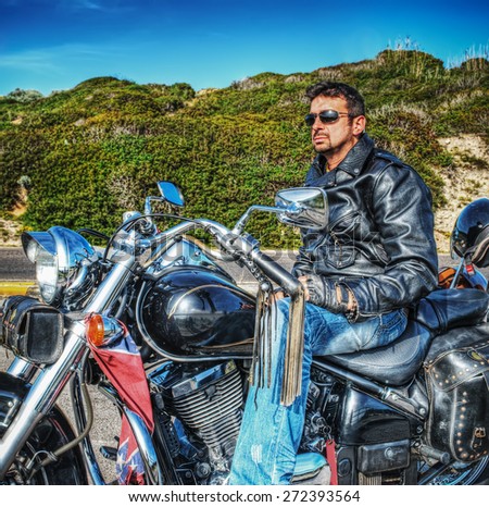 side view of a biker on a classic motorcycle in hdr