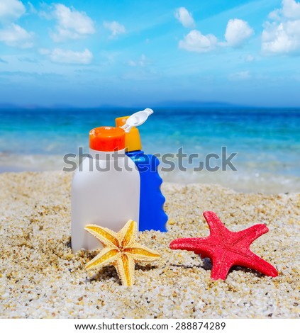 suntan lotion bottles and starfish by the sea