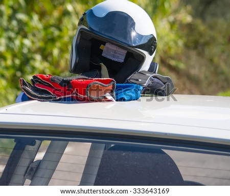 driver helmet and gloves on a car rooftop
