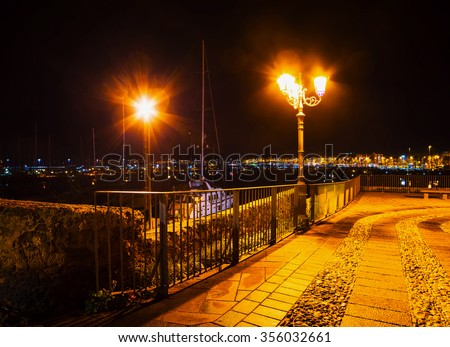 metal fence in Alghero shoreline at night, Italy