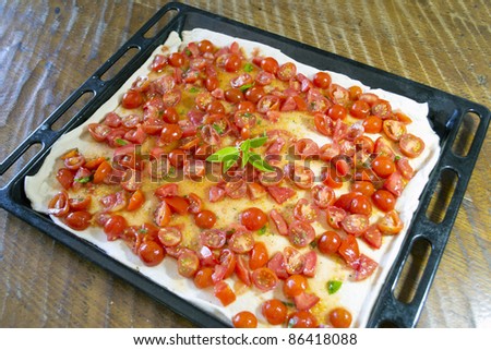 uncooked pizza in a black pan