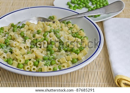 pasta with peas and cheese on a bamboo place mat