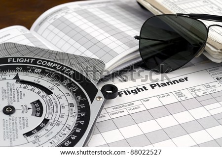 pilot style sunglasses on a flight plan paper