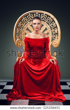 A woman in a luxurious red dress sitting on a golden throne