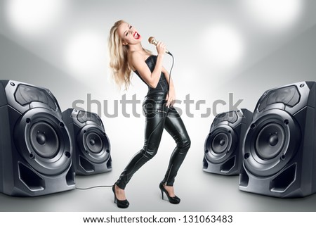 Karaoke singer at night in black leather clothing