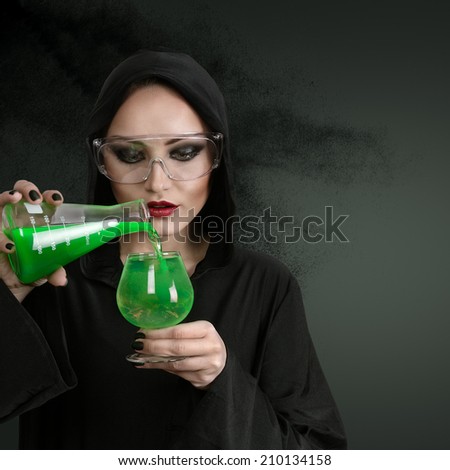 Young beautiful woman in black hood with poison