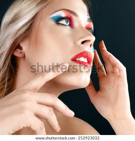 Beautiful young blonde woman with italian flag creative make-up studio shot