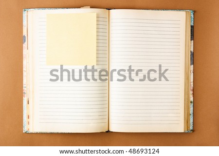 Old notebook with stained pages on brown paper surface. Useful for web site template