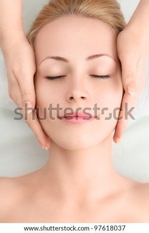 stock photo Young sexy woman in spa gets a facial massage