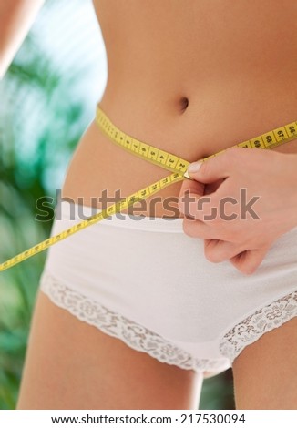 Perfect female body. Measuring waist and hips.