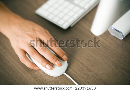 Female hand on a computer mouse