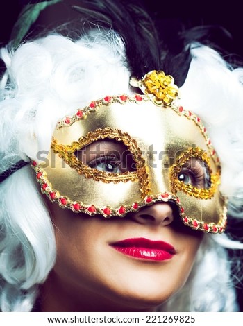 Woman wearing beautiful mask and old fashion wig.